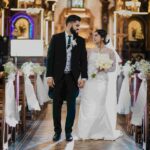 The perfect church wedding where the groom and bride hand in hand look at each other admiringly.