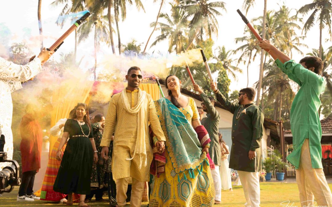 People with colorful smoke stick welcoming the bride and the groom.