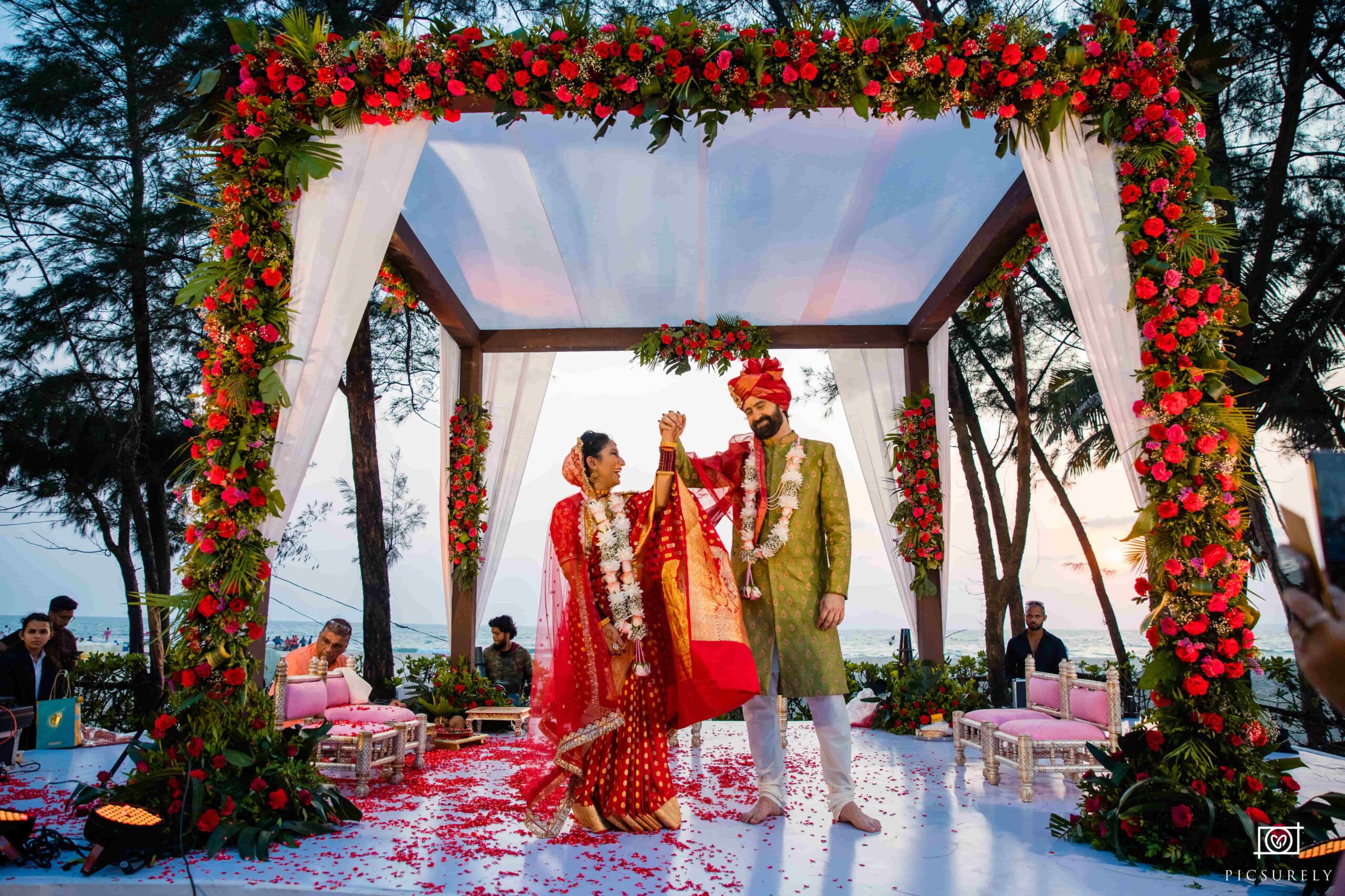 The groom lifting the bride's hand as they admire each other.